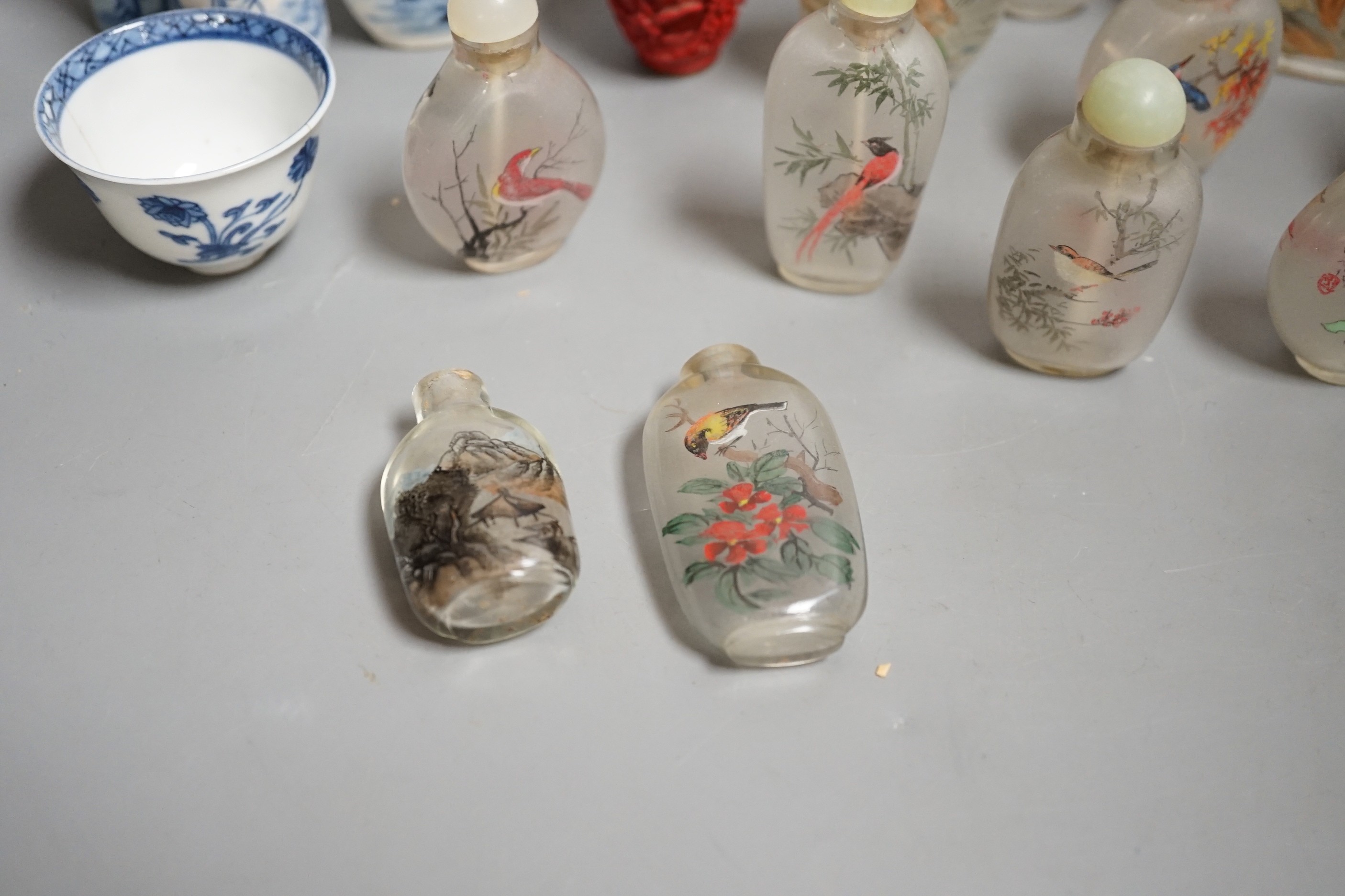 A collection of 20th century Chinese export reverse painted snuff bottles with associated blue and white porcelain examples, some 19th century